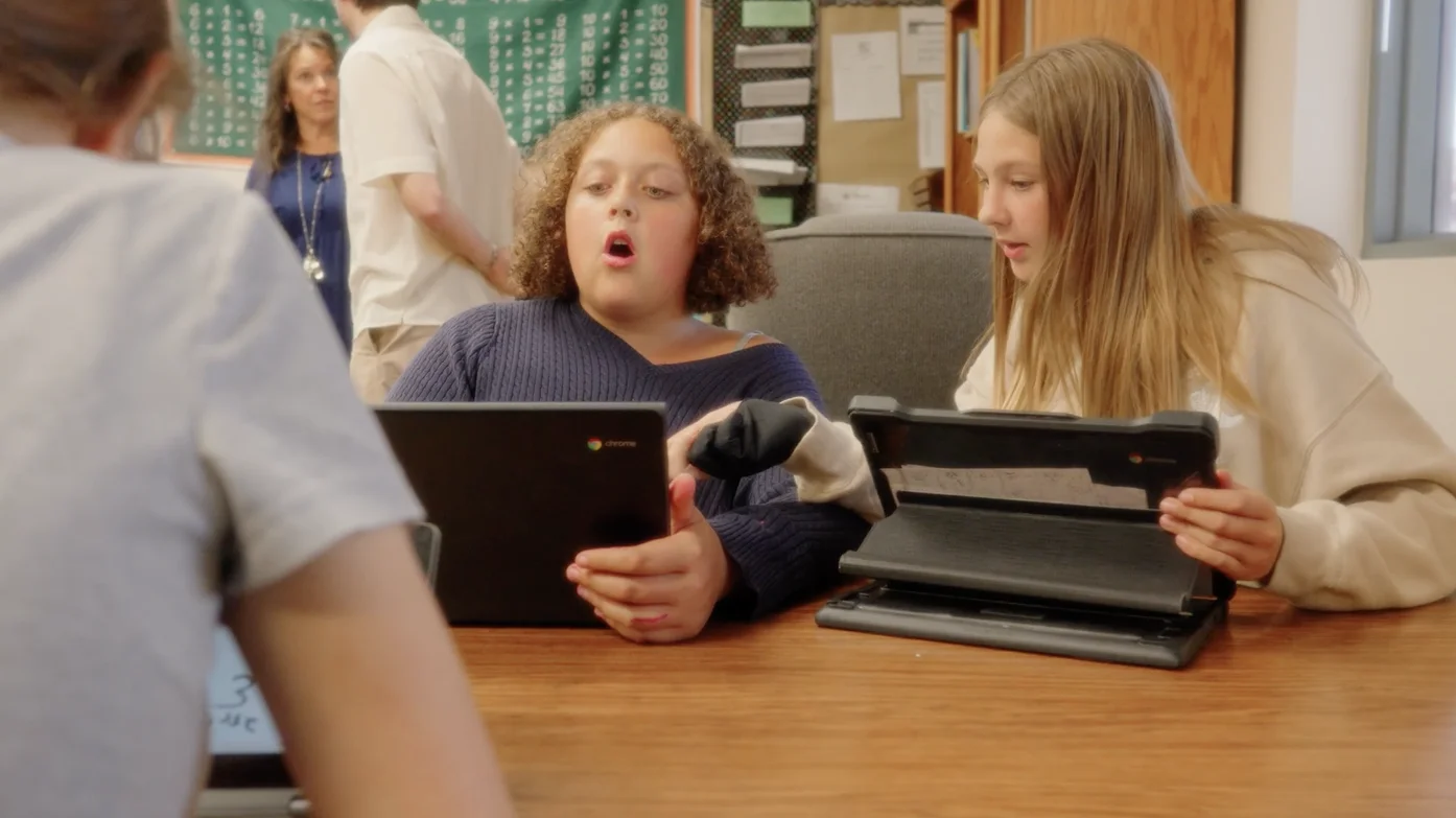 Two students reacting to their work on Goblins in class